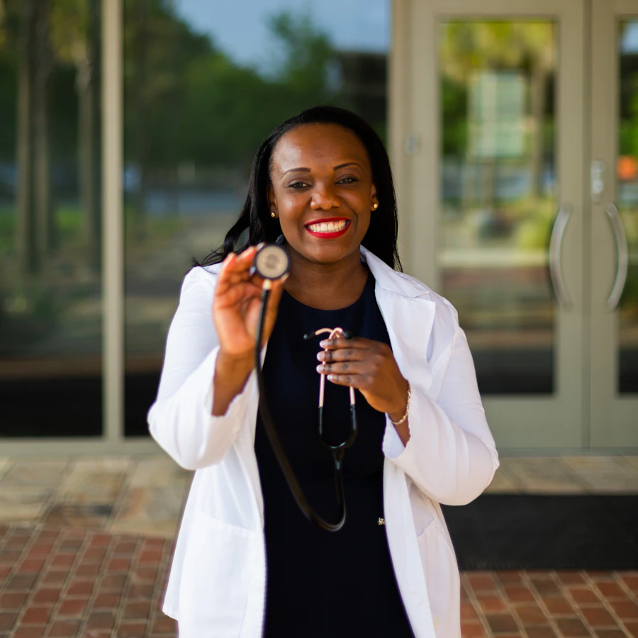Physician holding a stethoscope, ready for patient consultation